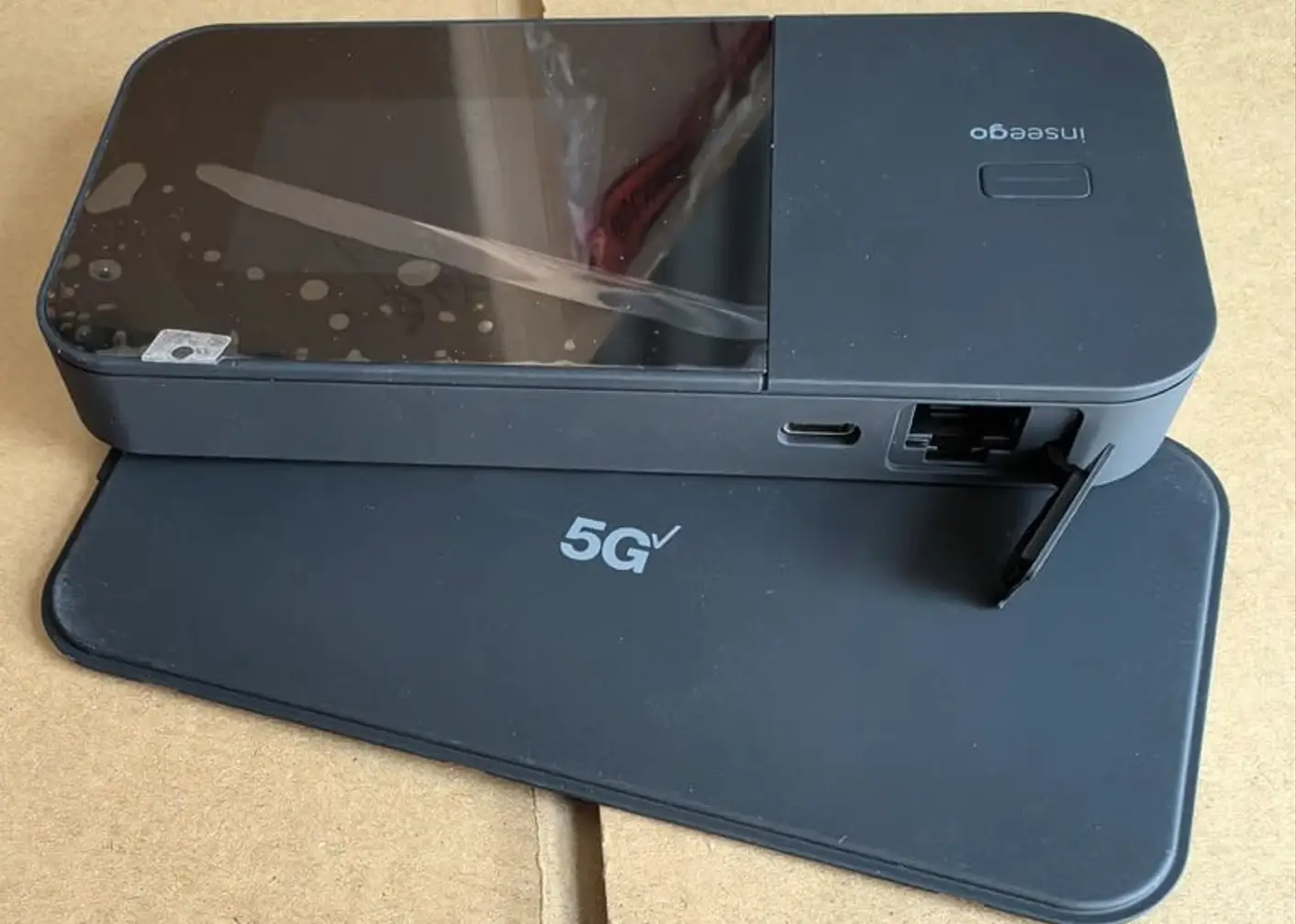 Inseego MiFi X PRO 5G hotspot side view showing USB-C, Ethernet port, SIM tray, 5G UW branding