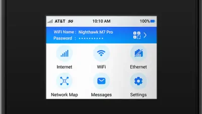 Netgear Nighthawk M7 Pro MR7400 5G mobile router with AT&T branding showing touchscreen home menu